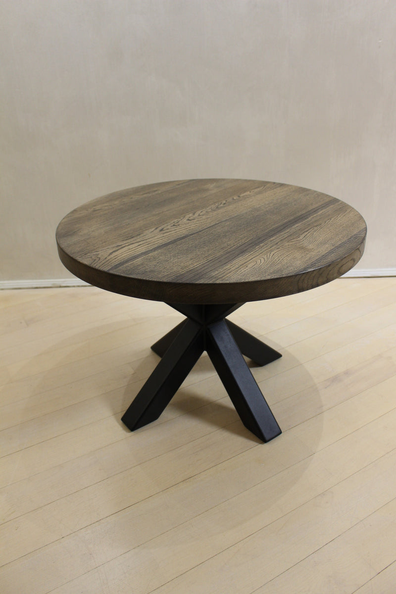 Handcrafted round wooden coffee table with circular top and sculptural spider base, perfect for modern living rooms