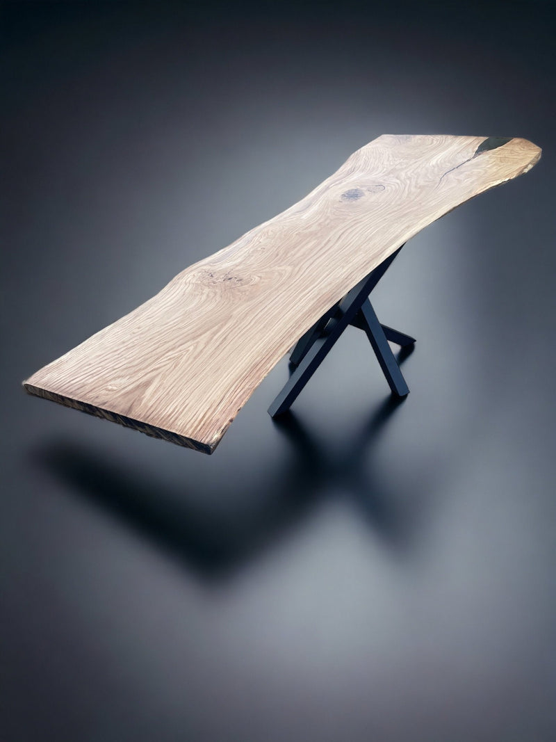 One-piece oak wood slab dining table with natural edge and industrial powder-coated steel legs