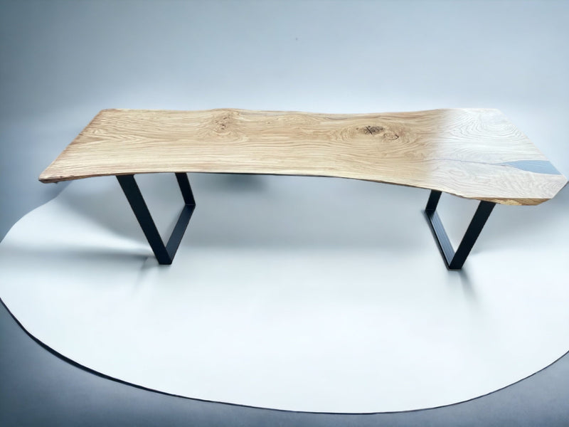 Handcrafted solid oak monolith table with live edge top and U-shaped metal base, bespoke dining furniture