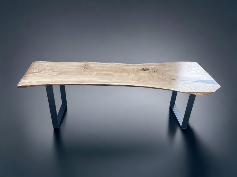 Premium oak slab dining table with raw natural edges and spider-style metal legs for contemporary interiors