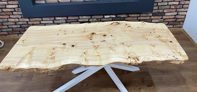 Solid oak slab dining table with white metal frame and natural contours, modern rustic furniture