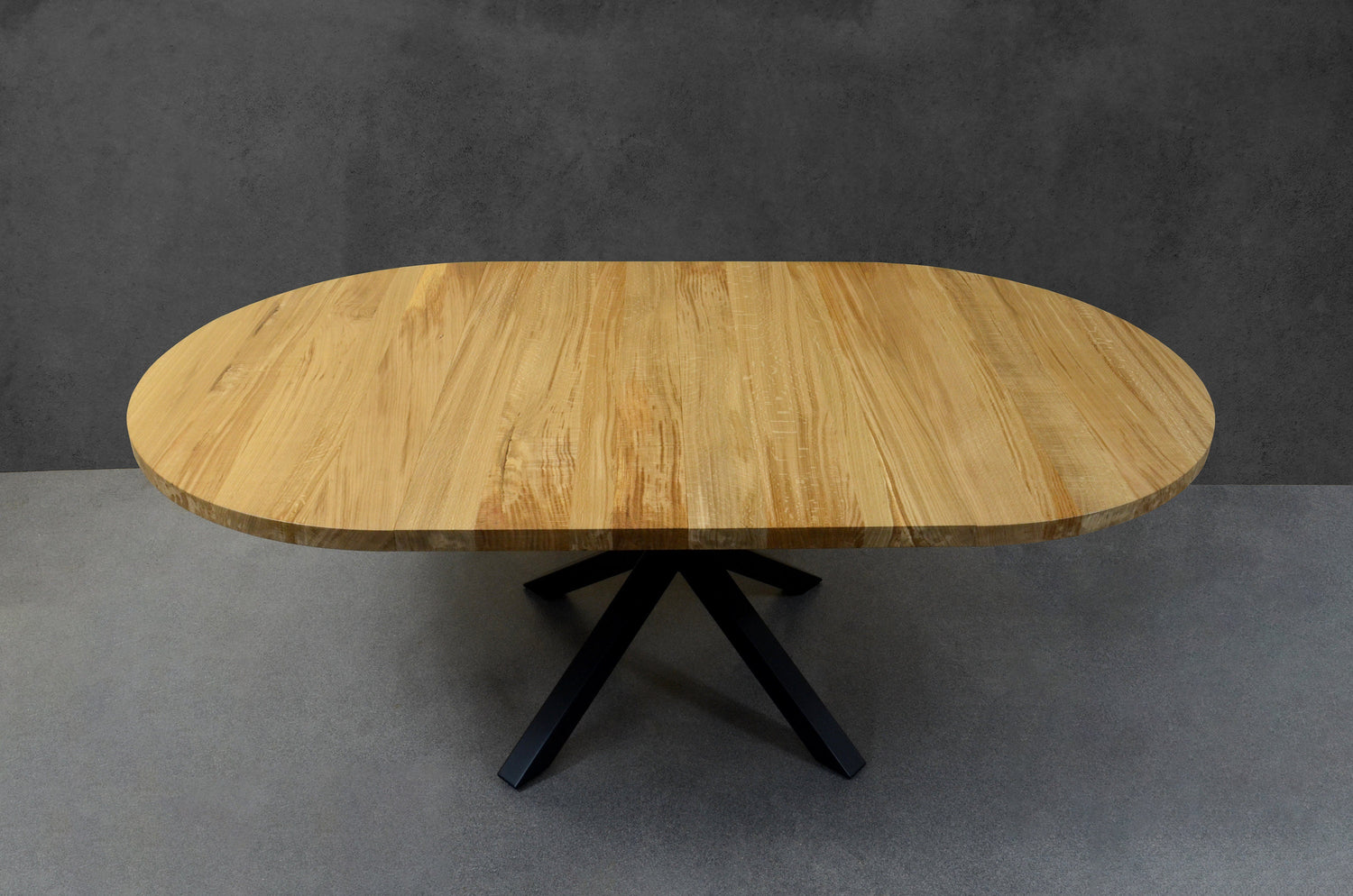Artisan-crafted oval extendable oak table with sleek black steel legs, luxury dining furniture