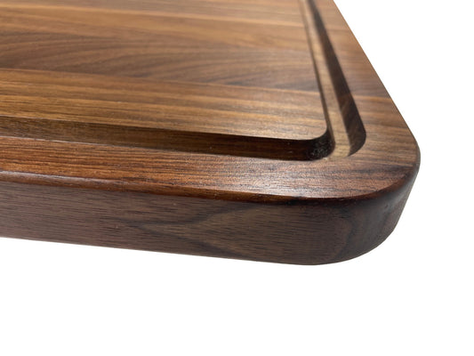 Handcrafted walnut charcuterie board with rich wood grain, perfect for cheeses, meats, and appetizers