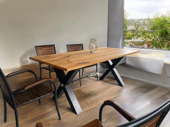 Large rectangular ash wood table with robust X-shaped metal base, perfect for spacious dining areas