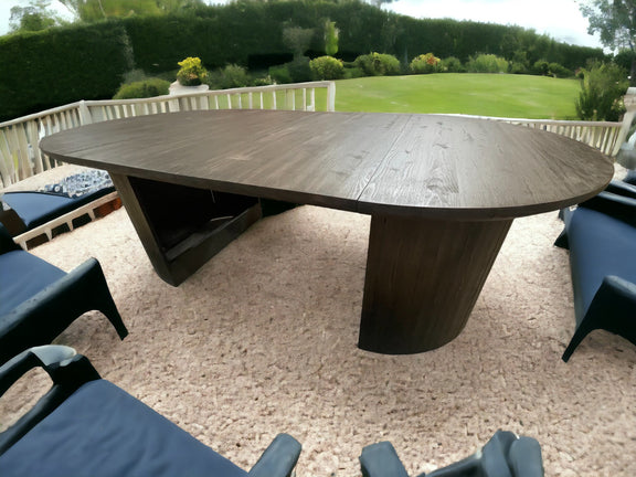 Luxury outdoor round oak dining table with thick solid wood top and designer boat-style base