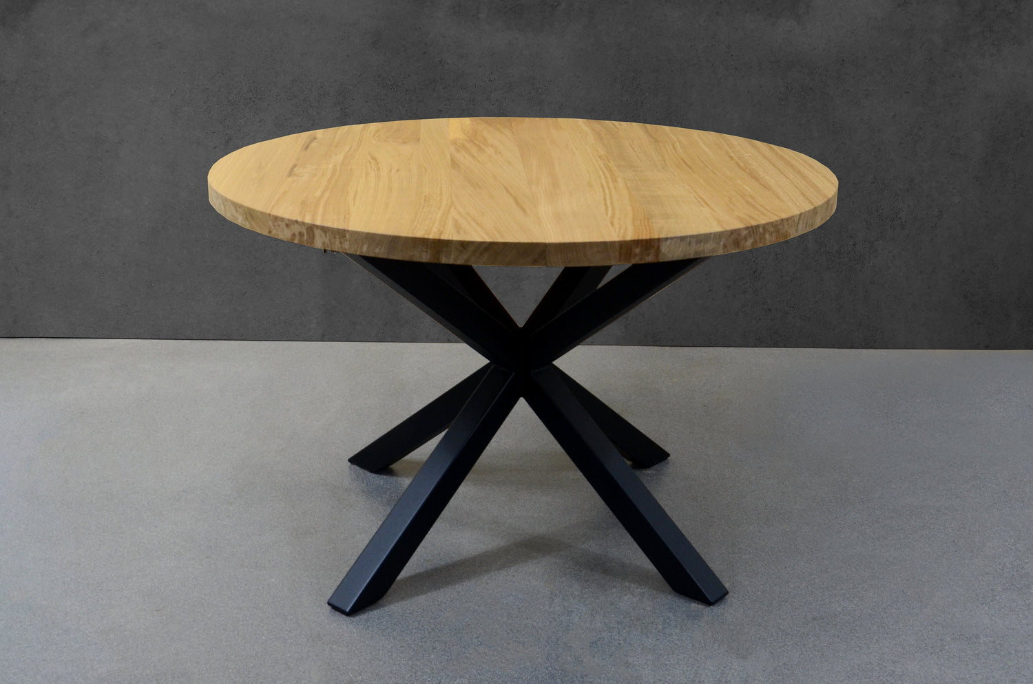 Minimalist Scandinavian oak round table with expansion feature and central steel support