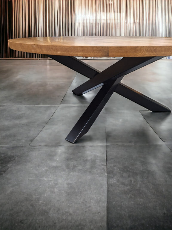  Modern round oak table with X-frame metal legs – ideal for open-plan living spaces and design-focused homes