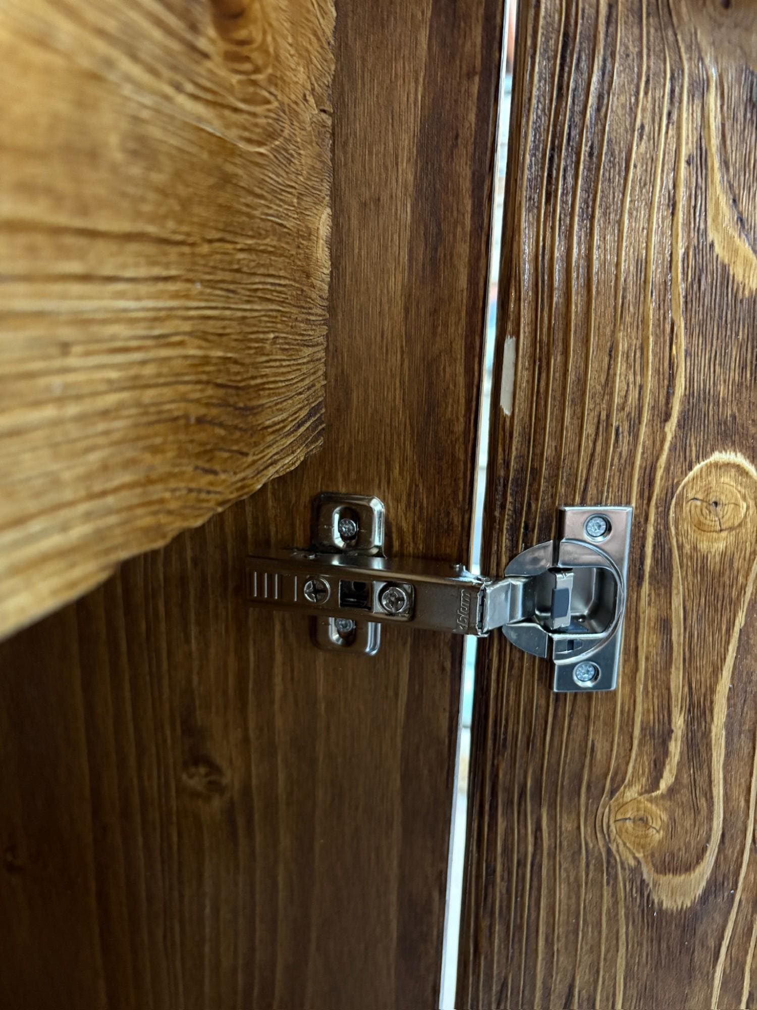 Close-up of thick pine wood desktop with integrated drawer and black steel legs, industrial executive desk