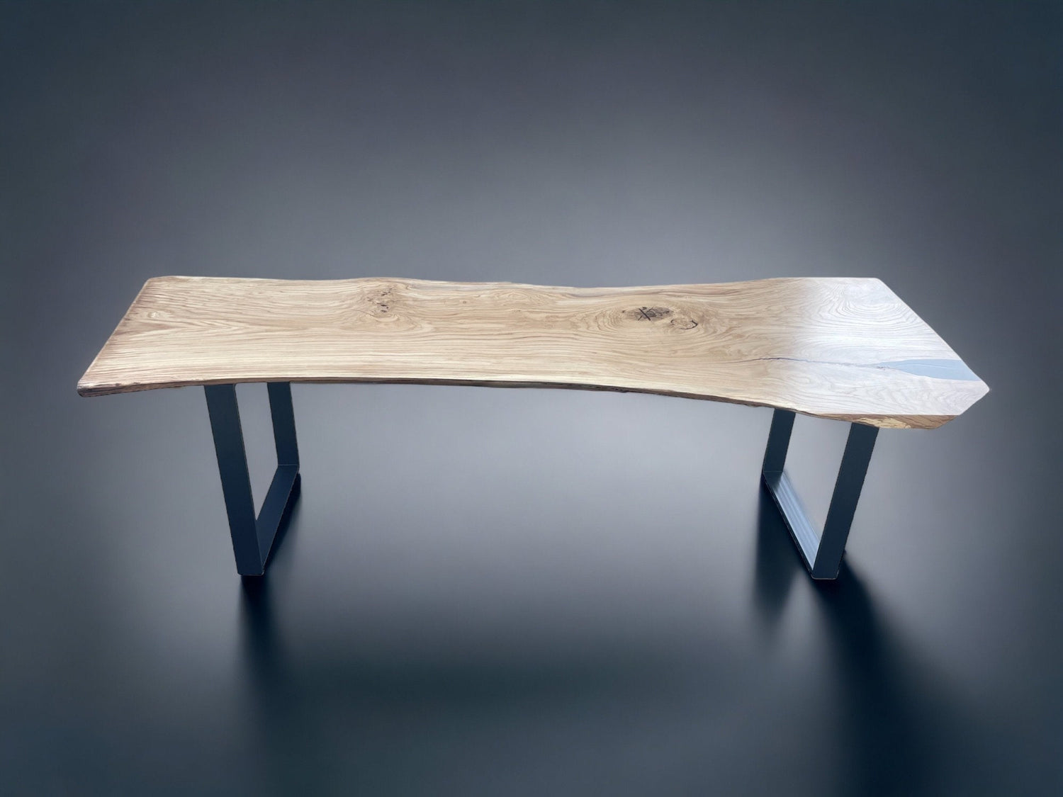 Premium oak slab dining table with raw natural edges and spider-style metal legs for contemporary interiors