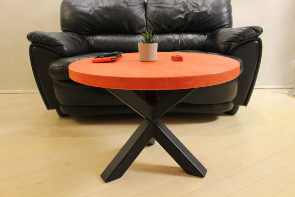 Red modern round coffee table combining solid wood craftsmanship with industrial black metal legs