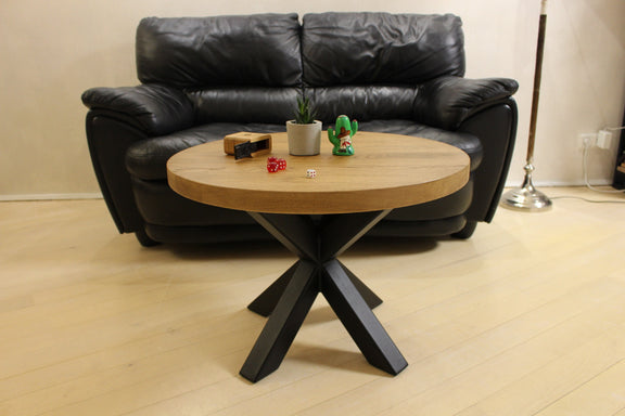 Solid wood round coffee table with black metal spider legs – modern Scandinavian lounge table