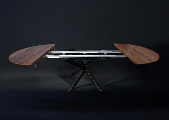 Space-saving round walnut table with hidden extension and black powder-coated steel legs