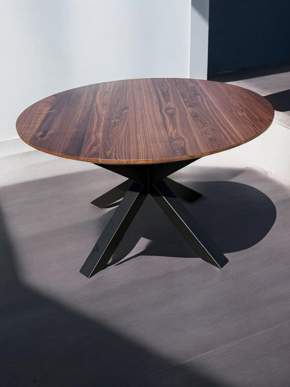 Expandable round American walnut dining table with X-shaped spider legs – luxury wood table with sculptural metal base