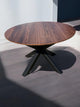 Expandable round American walnut dining table with X-shaped spider legs – luxury wood table with sculptural metal base